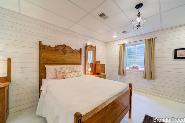 7561 Wiczer Dr, Whitehall, MI 49461 - bedroom featuring wood walls and a chandelier