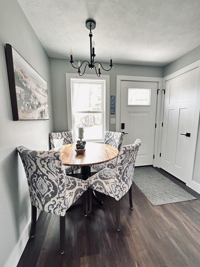 855 W Locust St, White Cloud, MI 49349 - dining area with wood finished floors, a chandelier, a textured ceiling, breakfast area, and baseboards