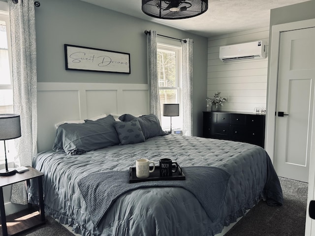 855 W Locust St, White Cloud, MI 49349 - carpeted bedroom featuring a wall mounted air conditioner, a decorative wall, and wainscoting