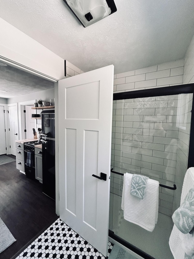 855 W Locust St, White Cloud, MI 49349 - bathroom featuring a shower stall and a textured ceiling