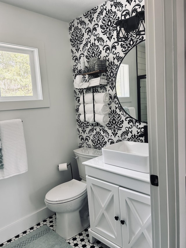 855 W Locust St, White Cloud, MI 49349 - half bathroom featuring plenty of natural light, vanity, toilet, and baseboards