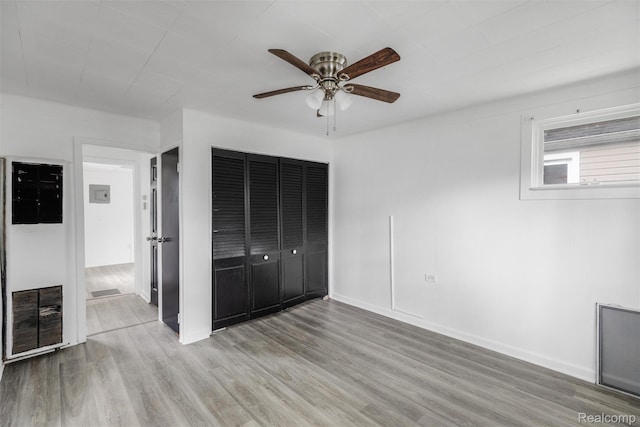 20515 Hollywood St, Harper Woods, MI 48225 - unfurnished bedroom with wood finished floors, a closet, ceiling fan, and baseboards