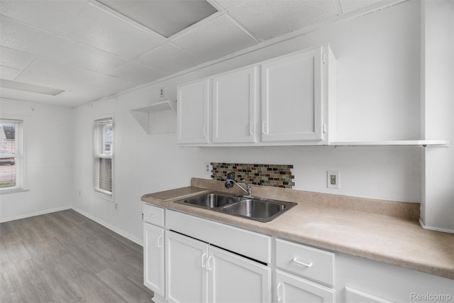 20515 Hollywood St, Harper Woods, MI 48225 - kitchen with a sink, a paneled ceiling, wood finished floors, and white cabinetry