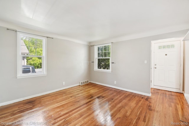 6008 Andersonville Rd, Waterford, MI 48329 - unfurnished room with light wood finished floors, plenty of natural light, and baseboards