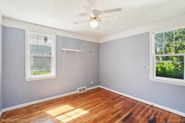 6008 Andersonville Rd, Waterford, MI 48329 - empty room featuring baseboards, wood finished floors, healthy amount of natural light, and a ceiling fan