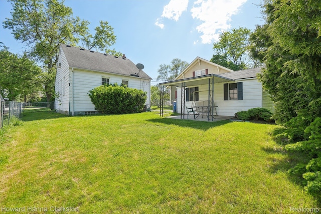 6008 Andersonville Rd, Waterford, MI 48329 - back of house featuring a patio area and a shingled roof