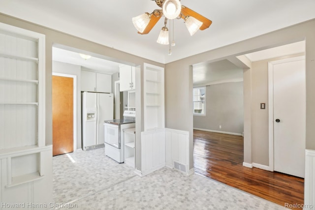 6008 Andersonville Rd, Waterford, MI 48329 - kitchen featuring white appliances, ceiling fan, light wood-type flooring, white cabinetry, and baseboards