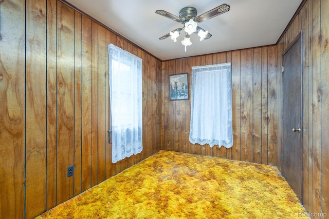 2500 Howe St, Shelby, MI 48317 - unfurnished room featuring wooden walls, a ceiling fan, and carpet