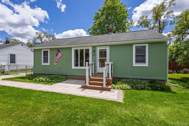 2500 Howe St, Shelby, MI 48317 - view of front facade with roof with shingles and a chimney