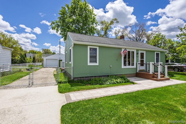 2500 Howe St, Shelby, MI 48317 - view of front of property featuring a garage, a chimney, a gate, driveway, and an outdoor structure