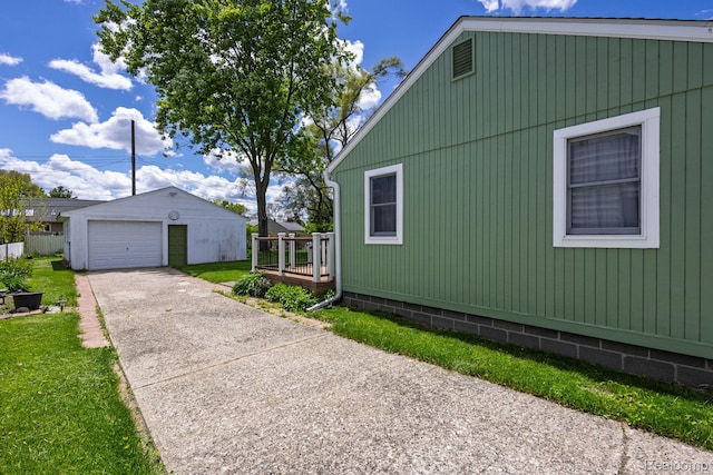 2500 Howe St, Shelby, MI 48317 - view of home's exterior featuring an outbuilding, a garage, concrete driveway, and a deck