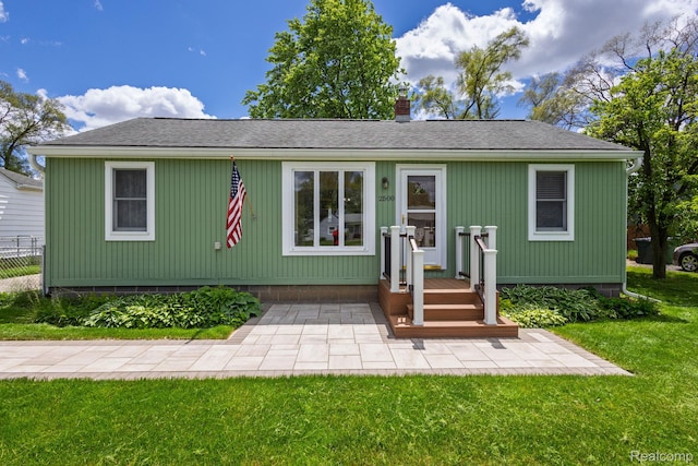 2500 Howe St, Shelby, MI 48317 - view of front of house with a chimney and a shingled roof
