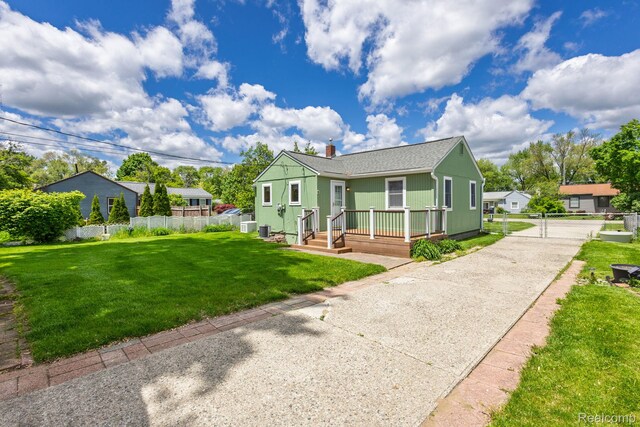 2500 Howe St, Shelby, MI 48317 - view of front of property with a chimney, driveway, and a shingled roof