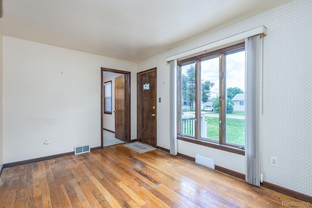2500 Howe St, Shelby, MI 48317 - unfurnished room with hardwood / wood-style flooring, wallpapered walls, baseboards, and plenty of natural light