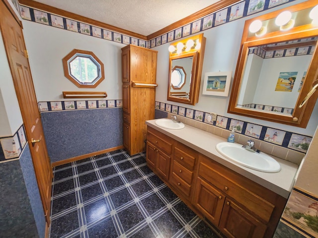 270 E Southern Rd, Coldwater, MI 49036 - bathroom featuring double vanity, a wainscoted wall, tile patterned floors, and a textured ceiling