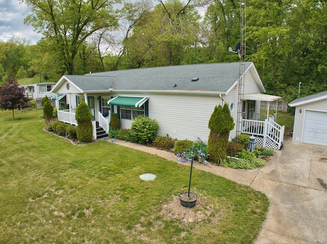270 E Southern Rd, Coldwater, MI 49036 - view of front facade with a porch, a front yard, an outdoor structure, concrete driveway, and a garage