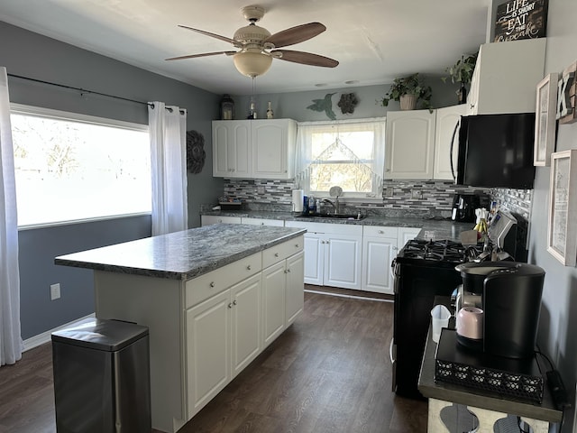 406 S Elm Ave, Jackson, MI 49203 - kitchen featuring a ceiling fan, decorative backsplash, gas stove, dark wood-type flooring, and white cabinets