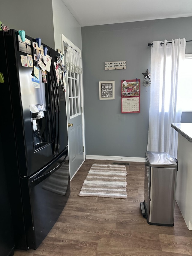 406 S Elm Ave, Jackson, MI 49203 - kitchen with black fridge, dark wood-type flooring, and baseboards