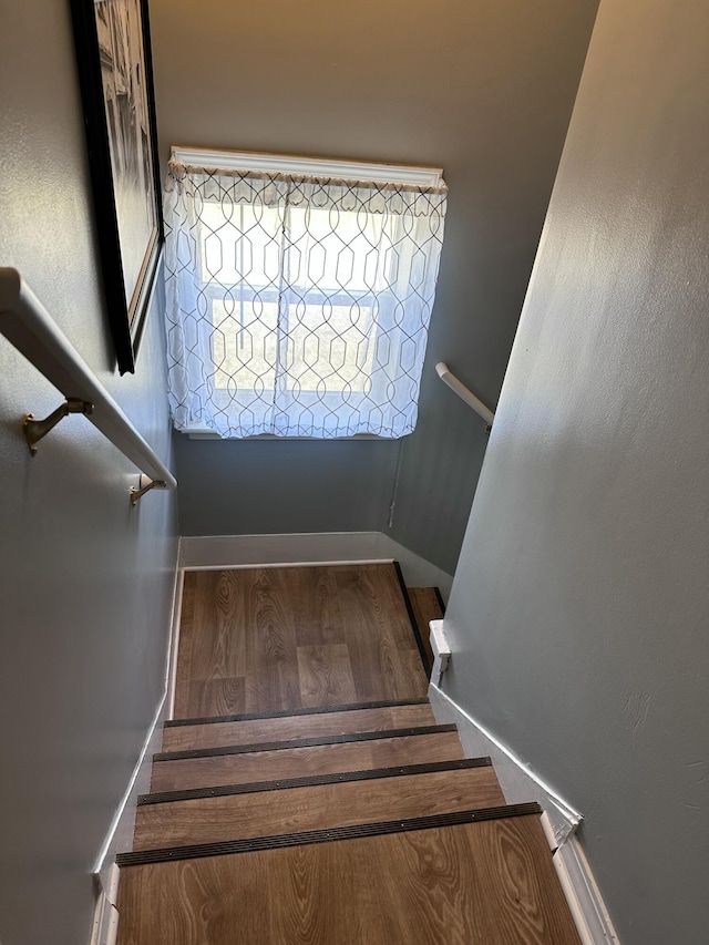 406 S Elm Ave, Jackson, MI 49203 - staircase featuring baseboards and wood finished floors