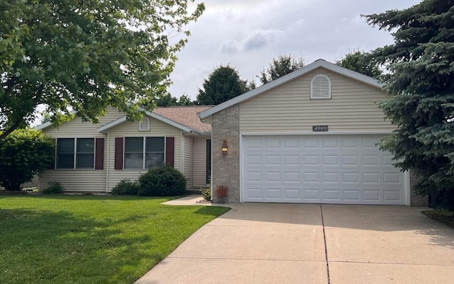 4009 Wild Meadow St, Kalamazoo, MI 49048 - ranch-style house with concrete driveway, a garage, a front lawn, and brick siding