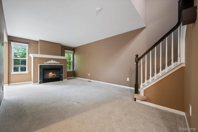 4632 Hunters Cir W, Canton, MI 48188 - unfurnished living room featuring carpet flooring, baseboards, a fireplace with flush hearth, and stairway