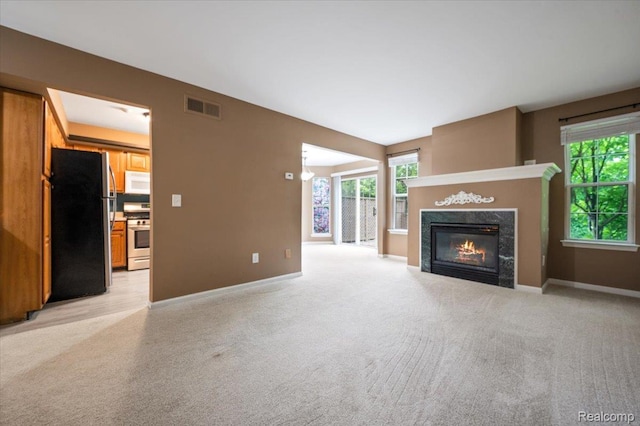 4632 Hunters Cir W, Canton, MI 48188 - unfurnished living room featuring light carpet, a high end fireplace, and baseboards