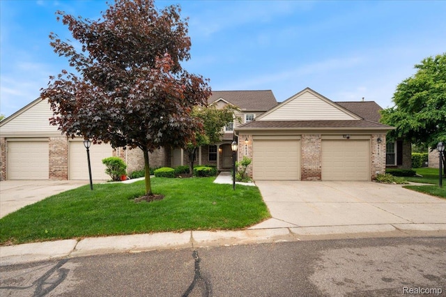 4632 Hunters Cir W, Canton, MI 48188 - view of front of home with brick siding, driveway, a front yard, an attached garage, and a shingled roof