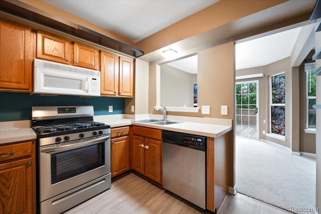 4632 Hunters Cir W, Canton, MI 48188 - kitchen featuring appliances with stainless steel finishes, a sink, light countertops, and brown cabinets