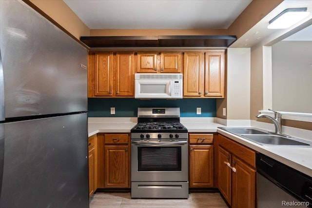 4632 Hunters Cir W, Canton, MI 48188 - kitchen featuring appliances with stainless steel finishes, a sink, and brown cabinets