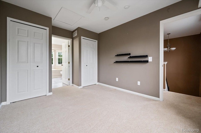 4632 Hunters Cir W, Canton, MI 48188 - unfurnished bedroom with carpet, baseboards, ensuite bath, a chandelier, and attic access