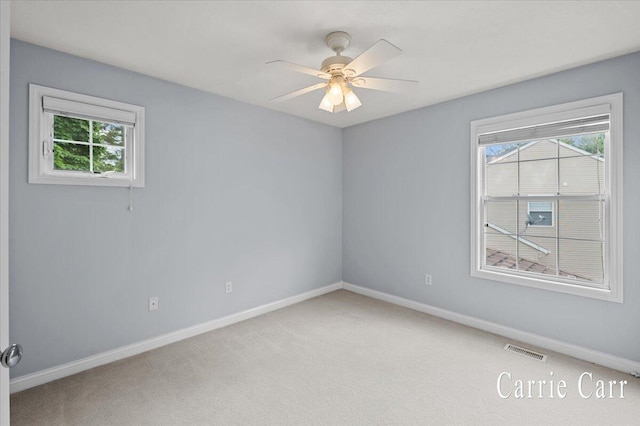 745 Abbey Mill Ct SE, Ada, MI 49301 - empty room with healthy amount of natural light, carpet floors, baseboards, and ceiling fan