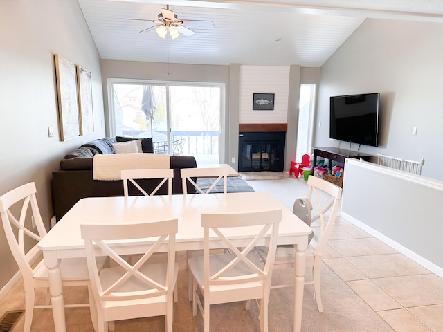 261 Black River St Unit F, South Haven, MI 49090 - dining area with lofted ceiling, ceiling fan, a fireplace, light tile patterned flooring, and light colored carpet
