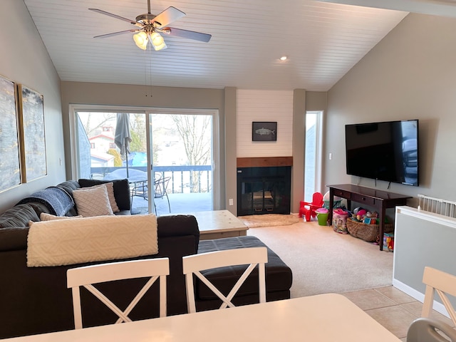 261 Black River St Unit F, South Haven, MI 49090 - living room featuring lofted ceiling, ceiling fan, light carpet, a large fireplace, and light tile patterned floors