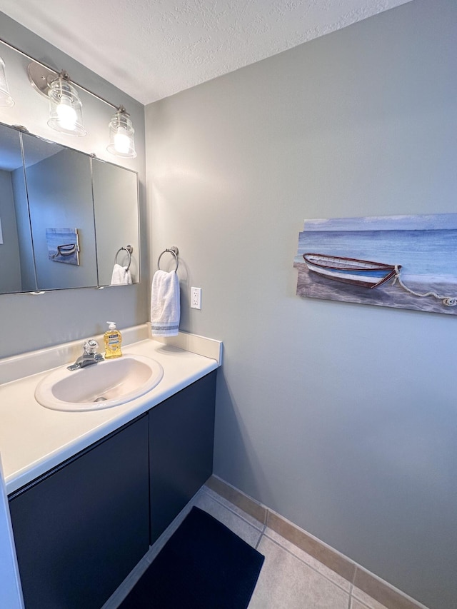 261 Black River St Unit F, South Haven, MI 49090 - bathroom with vanity, tile patterned floors, a textured ceiling, and baseboards