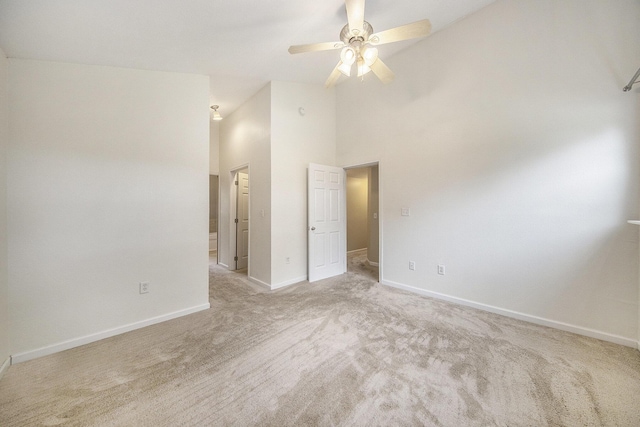 647 Church St, Grass Lake, MI 49240 - unfurnished room featuring light carpet, baseboards, a ceiling fan, and a high ceiling