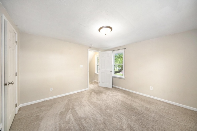 647 Church St, Grass Lake, MI 49240 - unfurnished room with baseboards and light carpet