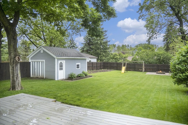 647 Church St, Grass Lake, MI 49240 - view of yard with a deck, an outbuilding, and a fire pit