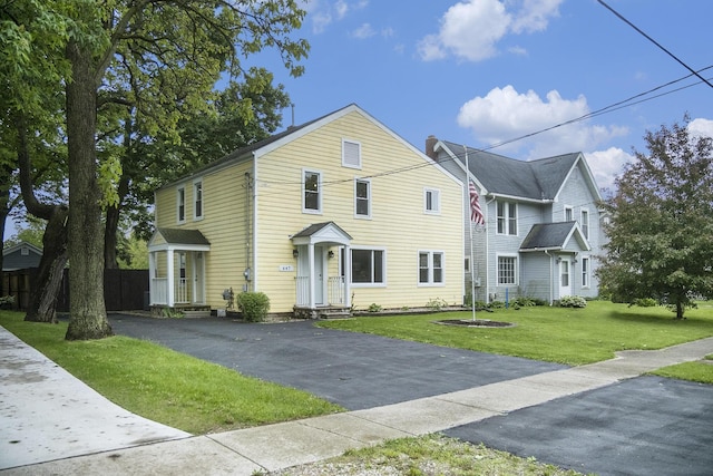 647 Church St, Grass Lake, MI 49240 - traditional-style home with a front lawn and asphalt driveway
