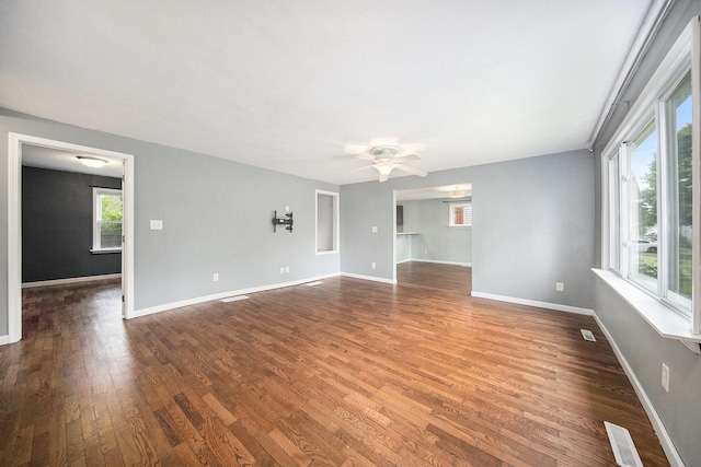 647 Church St, Grass Lake, MI 49240 - spare room featuring dark wood-style flooring, a ceiling fan, and baseboards