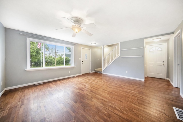 647 Church St, Grass Lake, MI 49240 - unfurnished living room featuring stairway, ceiling fan, wood finished floors, and baseboards