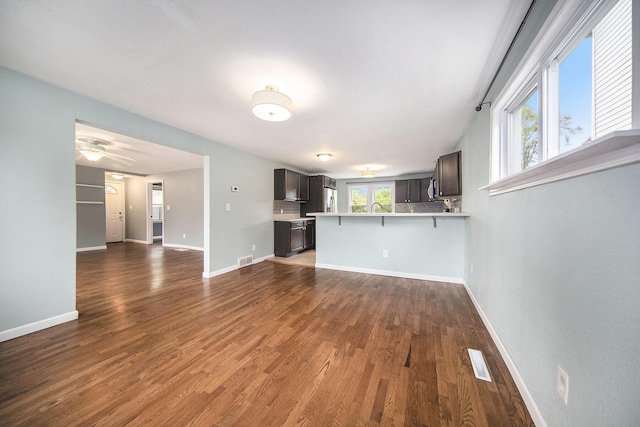 647 Church St, Grass Lake, MI 49240 - unfurnished living room with dark wood finished floors, a sink, baseboards, and ceiling fan