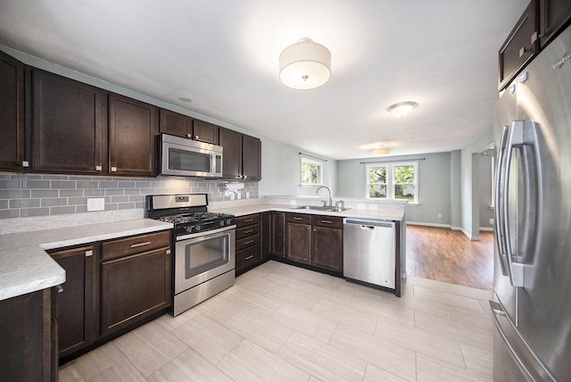 647 Church St, Grass Lake, MI 49240 - kitchen featuring appliances with stainless steel finishes, a sink, light countertops, and dark brown cabinets