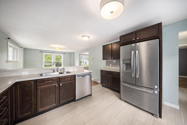 647 Church St, Grass Lake, MI 49240 - kitchen with appliances with stainless steel finishes, a sink, and dark brown cabinetry