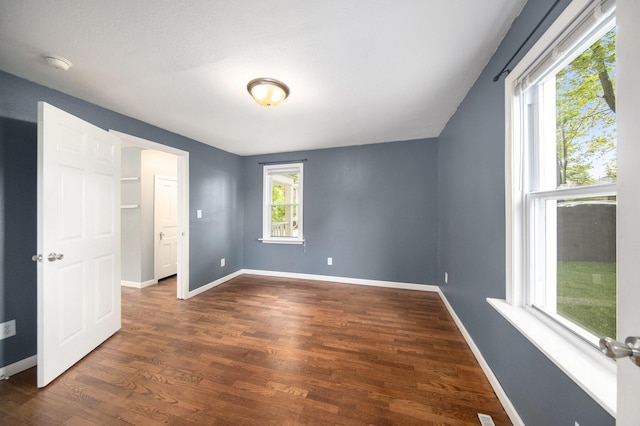 647 Church St, Grass Lake, MI 49240 - unfurnished bedroom featuring dark wood-style flooring and baseboards
