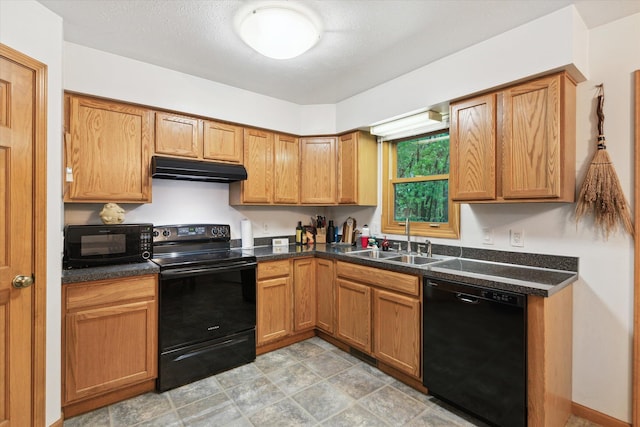 37965 County Road 388, Gobles, MI 49055 - kitchen featuring black appliances, a sink, under cabinet range hood, dark countertops, and brown cabinetry