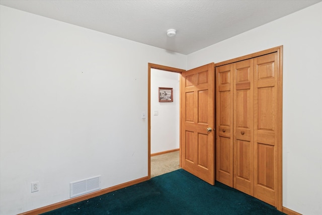 37965 County Road 388, Gobles, MI 49055 - unfurnished bedroom featuring dark carpet, baseboards, and a closet