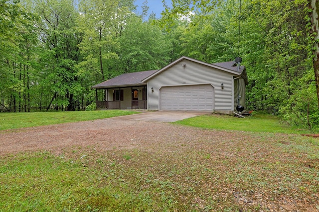 37965 County Road 388, Gobles, MI 49055 - view of front facade featuring driveway, a garage, a front yard, and a porch