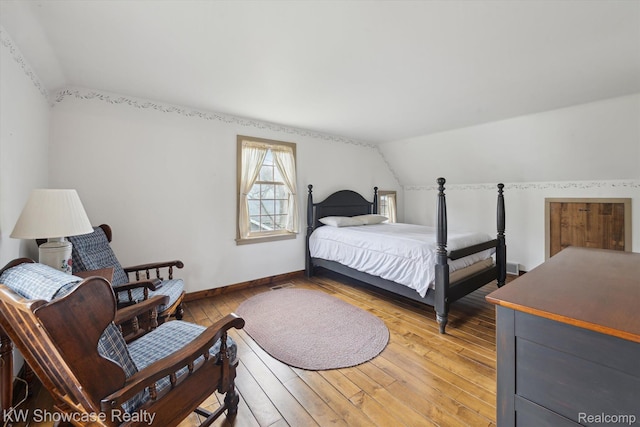 2095 E Nalone, Wixom, MI 48393 - bedroom with lofted ceiling, light wood-type flooring, and baseboards