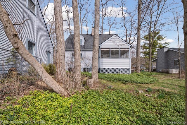 2095 E Nalone, Wixom, MI 48393 - view of side of property with a sunroom and roof with shingles
