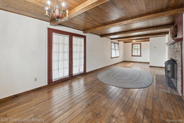 2095 E Nalone, Wixom, MI 48393 - unfurnished living room featuring a chandelier, wood-type flooring, a fireplace, wood ceiling with exposed beams, and baseboards